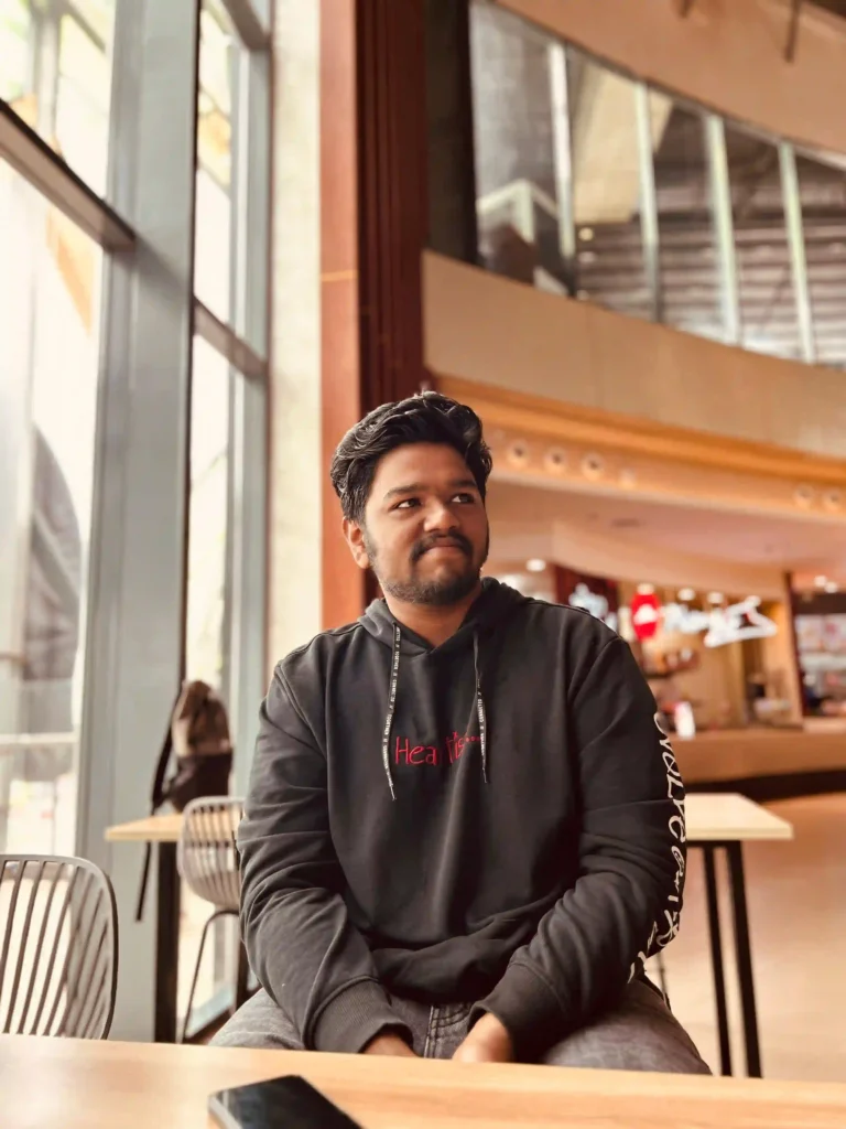 roi specialist in kochi is sitting on a chair